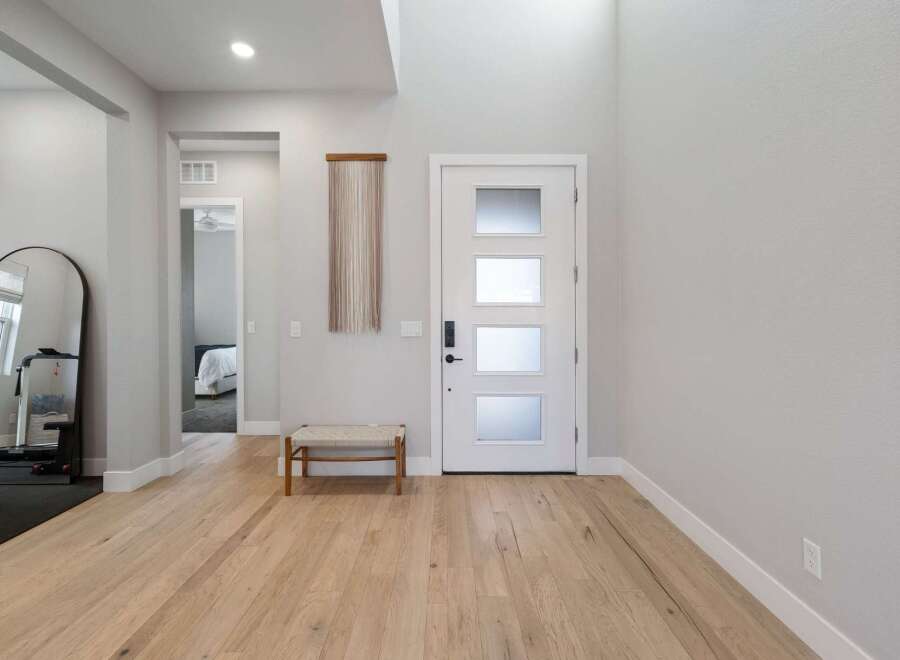Step into this inviting entryway with beautiful hardwood floors and a modern design.