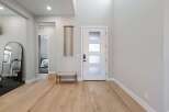 Step into this inviting entryway with beautiful hardwood floors and a modern design.