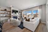 Step into luxury with this stunning living room, featuring a cozy fireplace and elegant floating shelves.