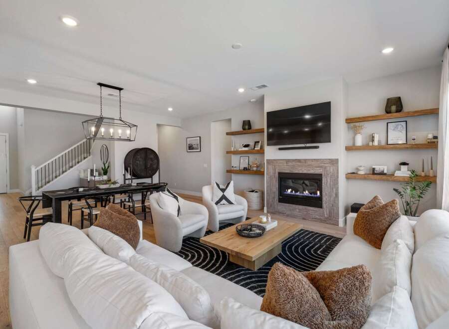 Step into luxury with this stunning property, boasting a modern living space with a cozy fireplace and elegant design.