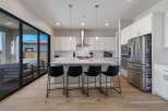 This stunning kitchen boasts a modern design with sleek white cabinetry and a spacious island, perfect for entertaining.