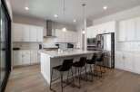 This stunning kitchen boasts a modern design with sleek white cabinetry and a spacious island, perfect for both cooking and entertaining.