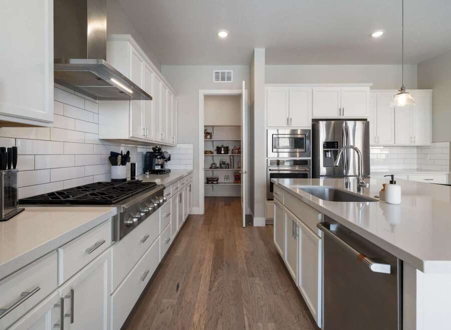 This stunning kitchen boasts modern elegance with its sleek design and high-end appliances.