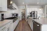 This stunning kitchen boasts modern elegance with its sleek design and high-end appliances.