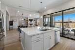 This stunning kitchen boasts a modern design with a spacious island, perfect for meal preparation and entertaining.