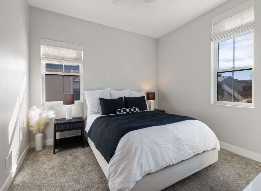 This stunning bedroom offers a serene retreat with its modern design and ample natural light.