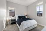 This stunning bedroom offers a serene retreat with its modern design and ample natural light.