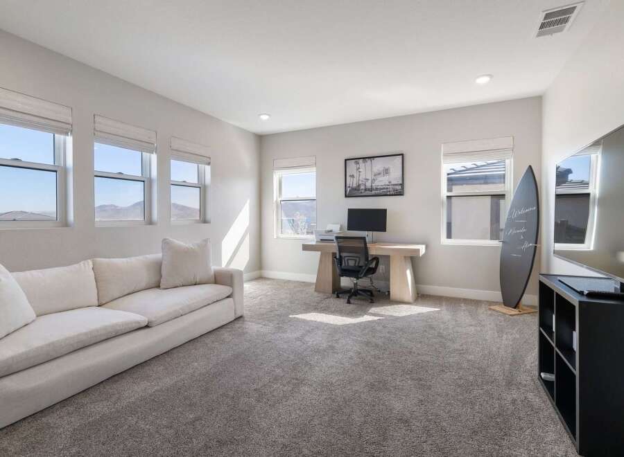 This spacious room offers a versatile space, perfect for a home office or a relaxing lounge area.