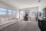 This spacious room offers a versatile space, perfect for a home office or a relaxing lounge area.