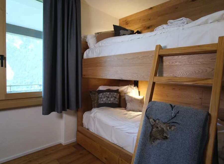 This cozy bedroom features a unique bunk bed design, perfect for maximizing space.