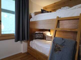 This cozy bedroom features a unique bunk bed design, perfect for maximizing space.