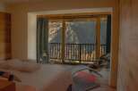 Experience breathtaking mountain views from this luxurious bedroom.