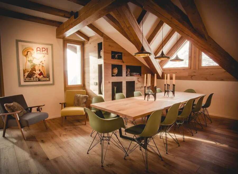 This stunning property boasts a unique architectural design with exposed wooden beams and a vaulted ceiling, creating a warm and inviting atmosphere.
