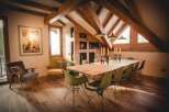 This stunning property boasts a unique architectural design with exposed wooden beams and a vaulted ceiling, creating a warm and inviting atmosphere.
