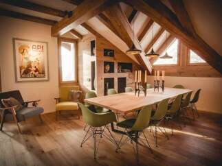 This stunning property boasts a unique architectural design with exposed wooden beams and a vaulted ceiling, creating a warm and inviting atmosphere.