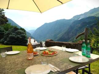 Enjoy breathtaking mountain views from this stunning outdoor dining area.