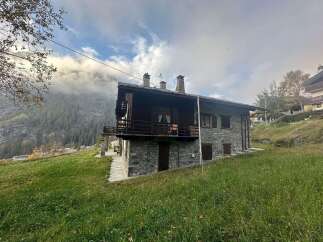 Nestled in a picturesque mountain setting, this charming stone house offers a tranquil escape.