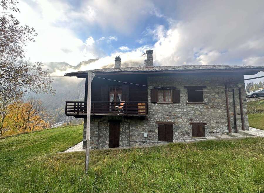 Discover the charm of this stunning stone house nestled in a picturesque mountain setting.
