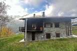 Discover the charm of this stunning stone house nestled in a picturesque mountain setting.