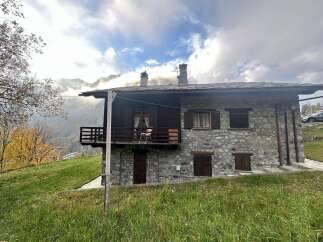 Discover the charm of this stunning stone house nestled in a picturesque mountain setting.