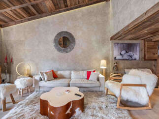 Experience luxury living in this stunning property, featuring a cozy living room with a plush rug and a unique coffee table.