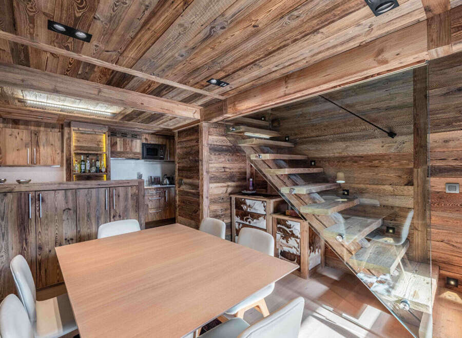 Experience rustic elegance in this stunning property, featuring exquisite wooden interiors and a modern glass staircase.