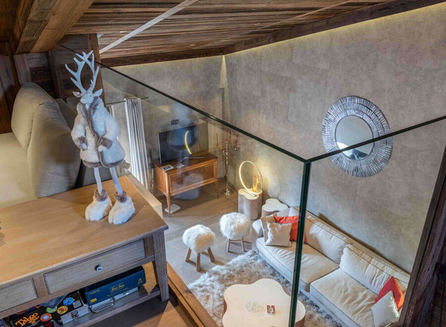 Experience luxury living in this stunning property, featuring a cozy living area with a plush sofa and stylish decor.