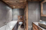 This stunning bathroom features a rustic design with wooden accents and a modern touch.