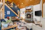 This stunning property boasts a cozy living room with a stone fireplace, perfect for relaxing evenings.