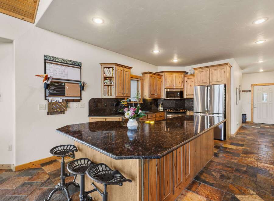 This stunning kitchen boasts a large island with a granite countertop, perfect for meal prep and entertaining.