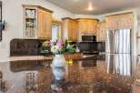 This stunning kitchen boasts beautiful wooden cabinetry, offering ample storage and a warm, inviting atmosphere.
