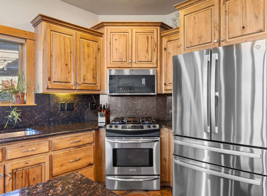 This stunning kitchen boasts beautiful wooden cabinetry, offering ample storage and a warm, inviting atmosphere.