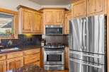 This stunning kitchen boasts beautiful wooden cabinetry, offering ample storage and a warm, inviting atmosphere.