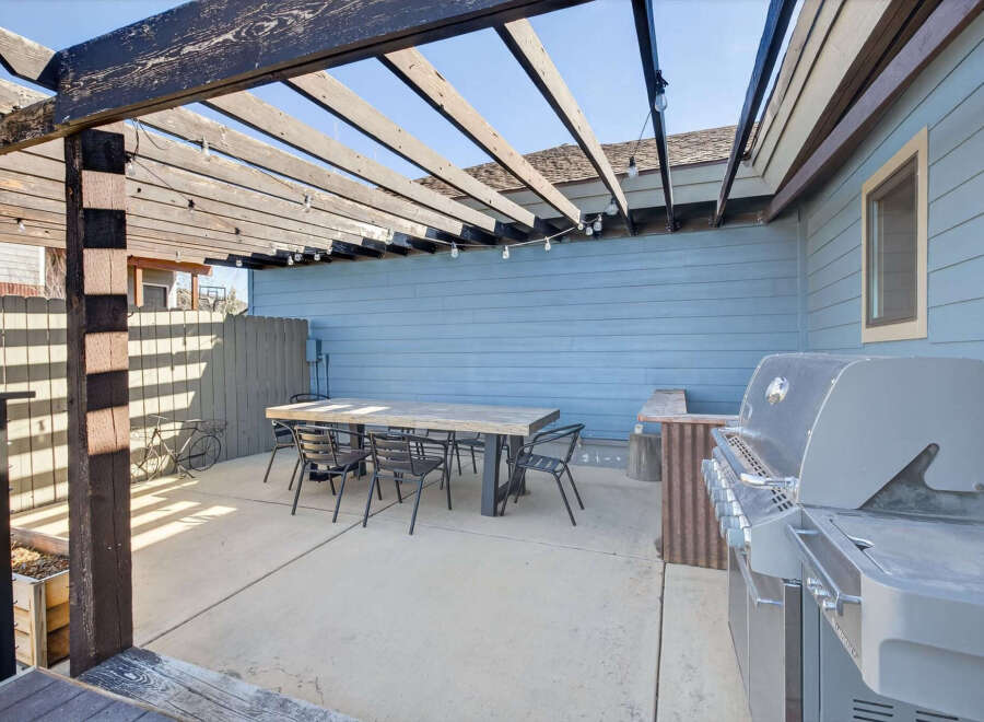 Enjoy outdoor living at its finest with this stunning patio space! Featuring a spacious concrete patio, a built-in grill, and a stylish pergola, this area is perfect for entertaining or relaxing.