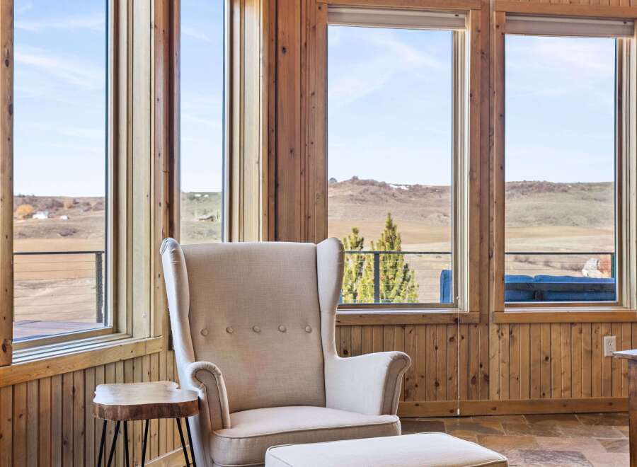 Experience the tranquility of this stunning property, featuring expansive windows that frame breathtaking views.