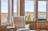 Experience the tranquility of this stunning property, featuring expansive windows that frame breathtaking views.