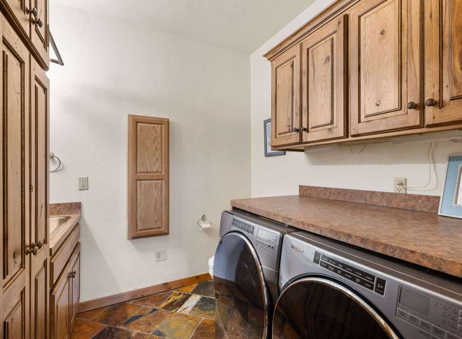 Step into this beautifully designed laundry room, featuring a modern Whirlpool washer and dryer set.