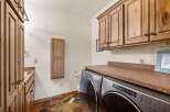 Step into this beautifully designed laundry room, featuring a modern Whirlpool washer and dryer set.
