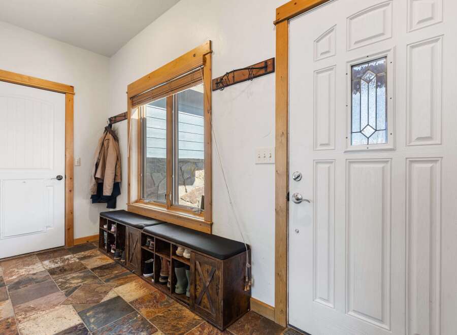 Step into this inviting entryway, showcasing a blend of rustic charm and modern design.
