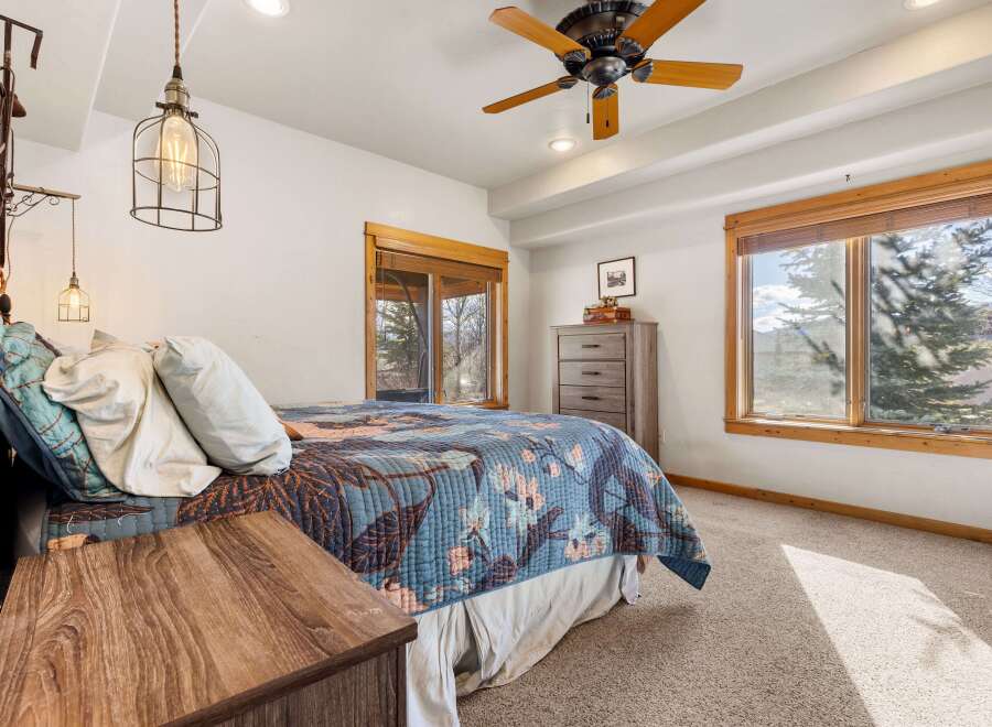 This charming bedroom offers a cozy retreat with its inviting ambiance and natural light.