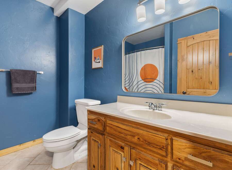 This charming bathroom features a stylish vanity with ample storage and a sleek countertop.