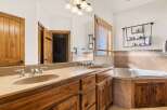 This luxurious bathroom boasts a stunning design with a double vanity featuring elegant fixtures and a spacious countertop.