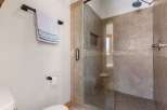 Step into a luxurious bathroom featuring a spacious walk-in shower with elegant tile work.