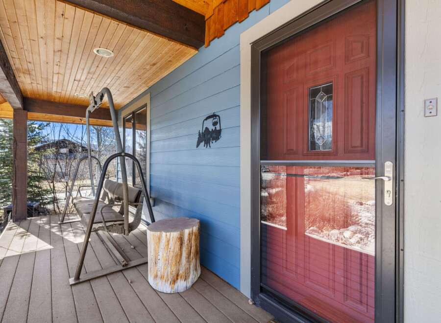 Step into the inviting embrace of this charming home, where a covered porch welcomes you with open arms.