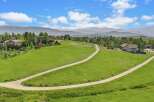 Discover your dream home nestled in a picturesque landscape with rolling green hills and majestic mountain views.