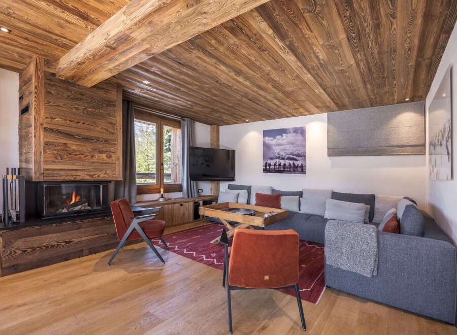 Experience the warmth and charm of this stunning living space, featuring a cozy fireplace and exquisite wooden accents.