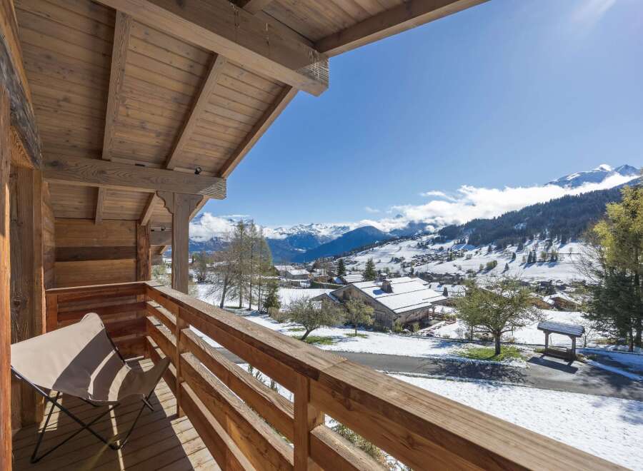 Enjoy breathtaking mountain views from this charming chalet balcony.