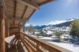 Enjoy breathtaking mountain views from this charming chalet balcony.