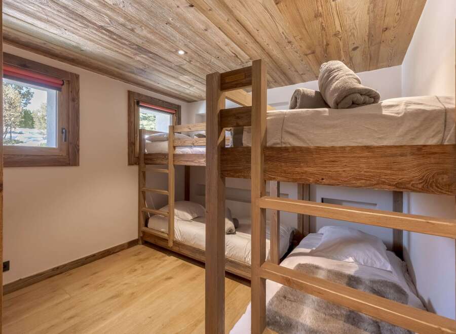This cozy bedroom features custom-built bunk beds, perfect for accommodating guests or family.