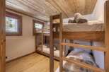 This cozy bedroom features custom-built bunk beds, perfect for accommodating guests or family.